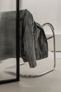 Kaboompics - Black Leather Jacket on Chrome Chair in Minimal Interior