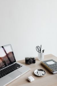 Kaboompics - Laptop, Camera, Notebook and AirPods on Desk with Copy Space