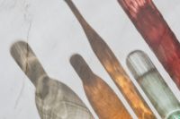 Kaboompics - Colorful Glass Bottle Shadows Across a Pale Background