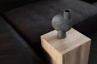 Kaboompics - Dark Leather Sofa with Wooden Cube Side Table and Cement Vase in Modern Living Room