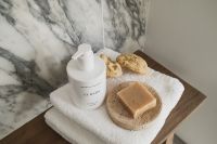 Kaboompics - Wooden Bench with Soap, Towel and Body Brush Against Arabescato Wall