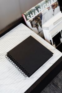 Kaboompics - Black Notebook on Marble with Architecture Books, Minimalist Desk Styling