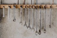 Kaboompics - Wide Row of Open-End Wrenches Against a Concrete Workshop Wall