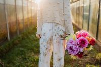 Kaboompics - Woman Walking With Dahlia Bouquet By Greenhouse