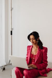 Kaboompics - Pink Suit Businesswoman Working on Laptop