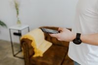 Kaboompics - Wide View of Man Using Smartphone with Wristwatch in Living Room