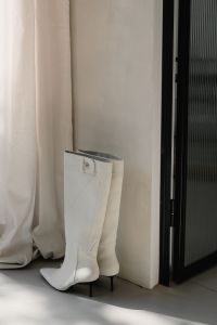 Kaboompics - White Knee-High Boots by Linen Curtain