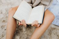 Kaboompics - Woman Reading an Open Book at the Beach, Summer Lifestyle Photo