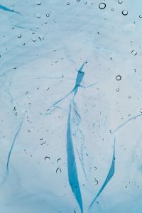 Kaboompics - Blue-Tinted Plastic Texture with Water Droplets, Abstract Pollution Background