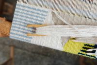 Kaboompics - Red Yarn on a Shuttle with Blue Wool
