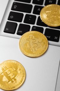Kaboompics - Gold Bitcoin Coin Beside Laptop Keyboard