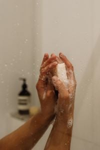 Kaboompics - Hands Lathering Soap Under Shower Water