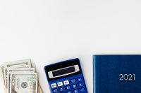 Kaboompics - 2021 Planner, Calculator and Cash for a Budgeting Flat Lay