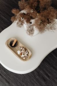 Kaboompics - White Coffee Table with Dried Pampas and Seashell Tray