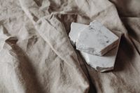 Kaboompics - White Marble Fragments on Rumpled Linen in Neutral Tones