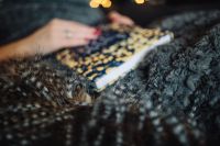 Kaboompics - Cozy Reading Scene with a Soft-Focus Book, Blanket and Fairy Lights