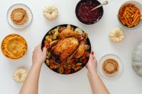 Kaboompics - Hands Centering a Roast Turkey among Thanksgiving Side Dishes