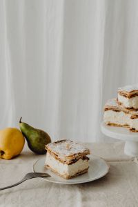 Kaboompics - Napoleonka Cake Slices with Pear and Lemon on a Neutral Table