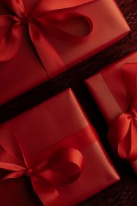 Kaboompics - Red Gift Boxes with Burgundy Ribbons on Textured Fabric