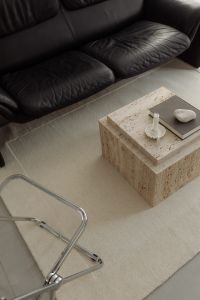Kaboompics - Black Sofa and Travertine Coffee Tables with Dried Arrangement