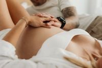 Kaboompics - Couple Holding a Pregnant Belly While Relaxing on a Bed