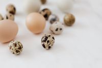 Kaboompics - Shallow-Focus Quail Eggs on White Marble with One Speckled Egg in Focus