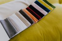 Kaboompics - Colorful Upholstery Fabric Swatches on Olive Green Velvet for Interior Design