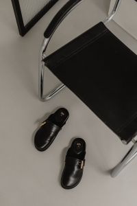 Kaboompics - Black Leather Mules Beside Chrome Chair