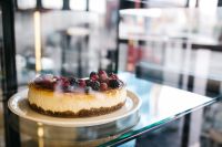 Kaboompics - Whole Berry Cheesecake in Bakery Display Case