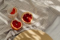 Kaboompics - Grapefruit Slices and Pink Drink on a Striped Beach Towel