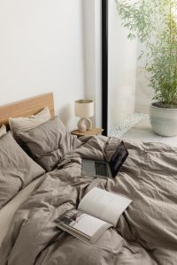 Kaboompics - Open Books and Lamp on a Bed by a Window