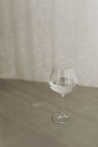 Kaboompics - Single Ribbed Wine Glass on a Soft Greige Tabletop