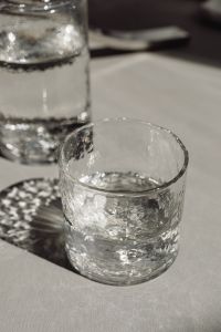Kaboompics - Selective-Focus Water Tumbler With Background Carafe