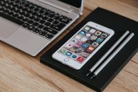 Kaboompics - Silver Acer Laptop And White Apple iPhone On Black Notebook With Pencils