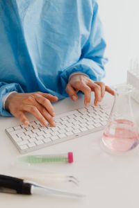 Kaboompics - Close-Up of Scientist Entering Lab Results on Computer