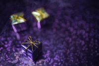 Kaboompics - Purple Gift Boxes with Gold Ribbons on a Bokeh Background
