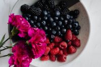 Kaboompics - Mixed Berry Bowl with Bright Pink Flowers