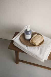 Kaboompics - Wooden Bench with Soap and Loofah on Folded Towels
