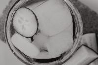 Kaboompics - Black and White Overhead Macro of Cucumber Slice and Ice in Detox Water, Monochrome Drink Texture