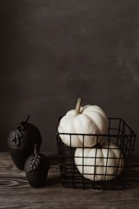 Kaboompics - White Pumpkins in Black Wire Basket on Dark Background