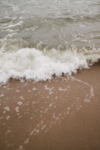 Kaboompics - Close-Up Wave Foam on Wet Sand