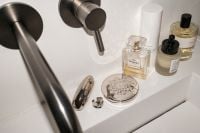 Kaboompics - Overhead Flash Photo of Perfume and Skincare on Sink Ledge
