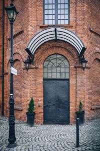 Kaboompics - Arched Black Doorway and Canopy on a Brick Loft Building