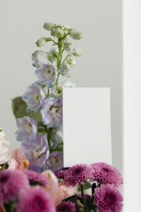 Kaboompics - Pale Blue Flower Stem beside Blank Vertical Card on Neutral Background