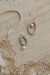 Kaboompics - Beige Satin Bra with Silver Earrings and Pearl Jewelry
