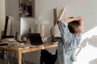 Kaboompics - Designer Stretching at Interior Design Workspace with Laptop and Swatches