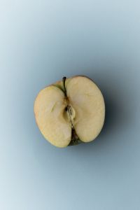 Kaboompics - Apple Half on Blue Background