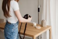 Kaboompics - Young Female Photographer Shooting Candle and Home Decor Setup
