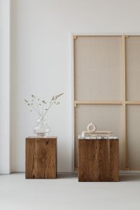 Kaboompics - Neutral Interior Still Life with Glass Vase, Books and Framed Canvas