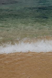 Kaboompics - Clear Ocean Wave Rolling Onto Sandy Beach